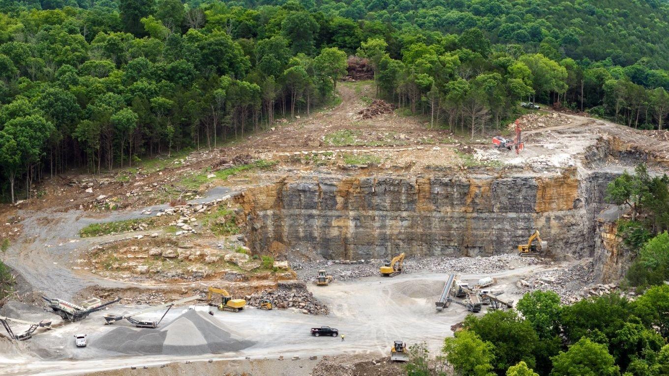Aerial view of open pit mining site of limestone materials extraction for construction industry