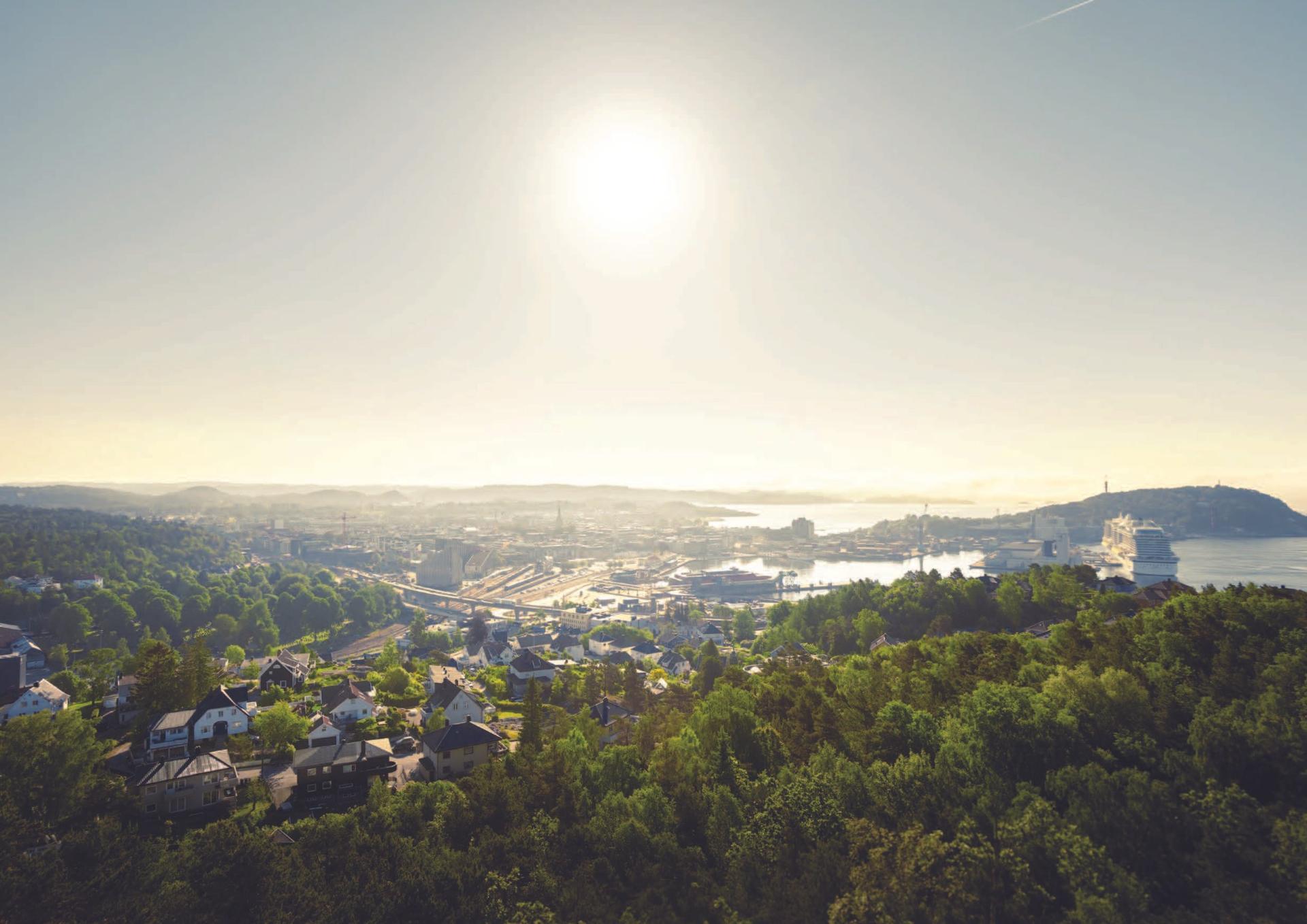 Aerial view of Kristiansand showing the Gartnerløkka area, where Ramboll is transforming the E18/E39 corridor to reconnect urban development with surrounding nature and coastline.